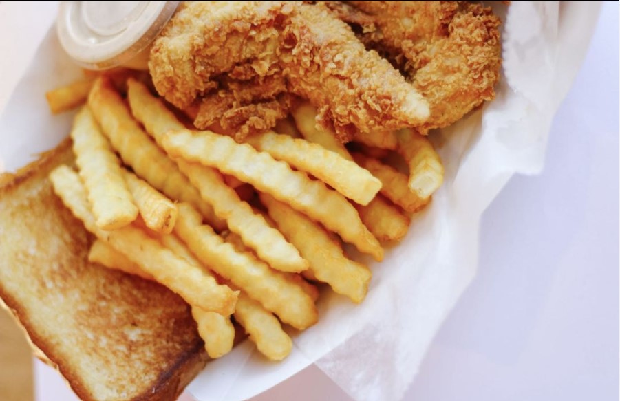 Chicken tenders, fries and toast in a basket by Mr. Charlie's Chicken